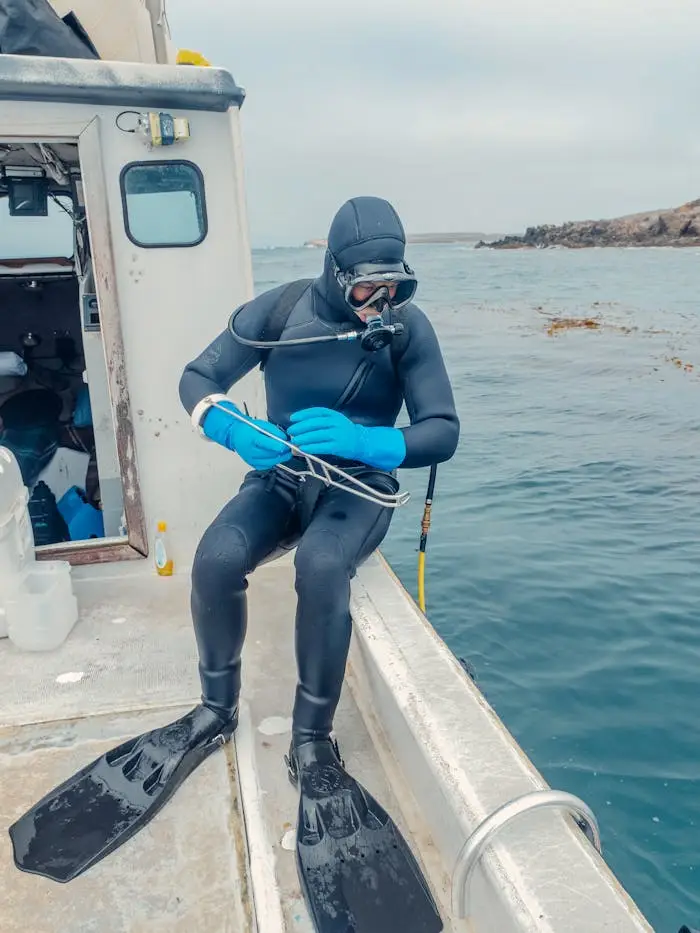 A scuba diver on a boat prepares to enter the ocean, ready for underwater exploration.